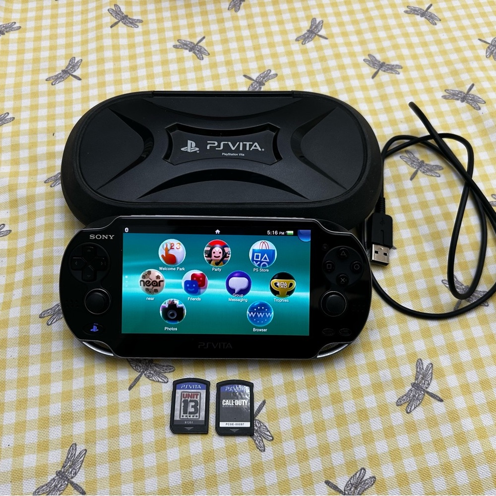 like new ps vita bundle (with hard protective case and two games!!)